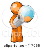 Orange Man Holding A Glass Electric Lightbulb Symbolizing Utilities Or Ideas Clipart Illustration