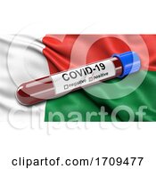 Flag Of Madagascar Waving In The Wind With A Positive Covid 19 Blood Test Tube