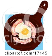 Poster, Art Print Of Fried Egg Sprinkled With Pepper Cooking In The Center Of A Frying Pan And Circled By Bacon