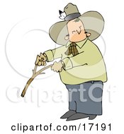 Caucasian Cowboy With A Feather In His Hat Looking Back Over His Shoulder While Handling A Stick While Water Witching Or Dowsing