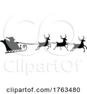 Silhouetted Santas Sleigh And Reindeer In Flight