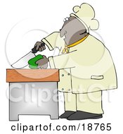Black Male Chef Carefully Slicing A Green Bell Pepper