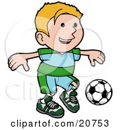 Poster, Art Print Of Happy Blond Boy Ion A Blue And Green Uniform Kicking A Soccer Ball During A Game