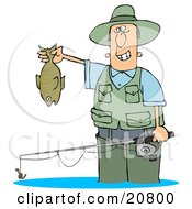 Man Wading In Water And Holding His Fishing Rod And Catch