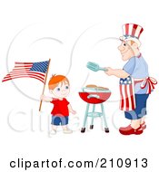 Patriotic Boy Waving An American Flag Near His Dad As He Barbecues Food For A Fourth Of July Picnic