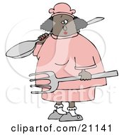 Black Chef Woman In A Pink Uniform And Chefs Hat Carrying A Large Fork And A Spoon On Her Shoulder