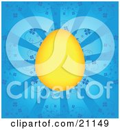 Clipart Illustration Of A Bright Yellow Dyed Easter Egg Over A Blue Background With Floral Vines And Rays Of Light