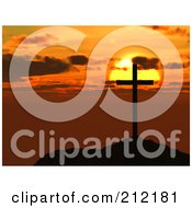 Silhouetted Cross On A Hilltop Against An Orange Sunset