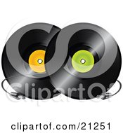 Two Black Vinyl Records With Orange And Green Labels And A Cable Between Them