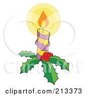 Lit Christmas Candle With Holly And Berries