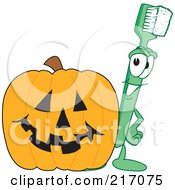 Green Toothbrush Character Mascot With A Halloween Pumpkin