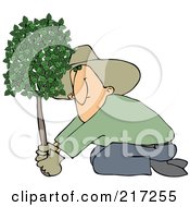 Kneeling Man Planting A Tree