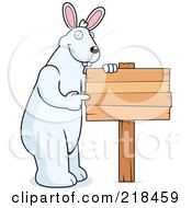 Poster, Art Print Of Big Rabbit Standing And Pointing To A Blank Wood Sign