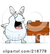 Poster, Art Print Of Plump White Rabbit Standing By A Blank Wood Sign