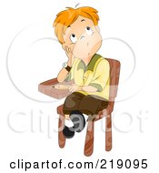 Red Haired School Boy Sitting In His Desk And Thinking