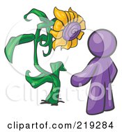 Purple Man Proudly Standing In Front Of His Giant Sunflower In His Garden