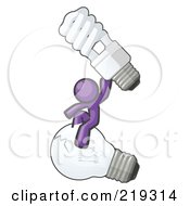 Purple Man Design Mascot Sitting On An Old Light Bulb And Holding Up A New Energy Efficient Bulb