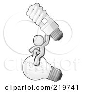 Royalty Free RF Clipart Illustration Of A White Man Design Mascot Sitting On An Old Light Bulb And Holding Up A New Energy Efficient Bulb by Leo Blanchette