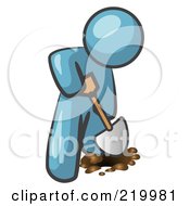 Denim Blue Man Using A Shovel To Dig A Hole For A Plant In A Garden