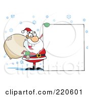 Poster, Art Print Of Jolly Santa Holding A Sack Over His Shoulder And Holding Up A Blank Sign In The Snow