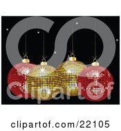 Two Yellow And Two Red Mirror Disco Christmas Ornaments Sparkling Suspended Over A Black Starry Background