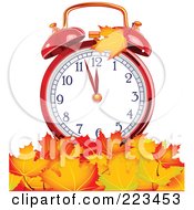 Red Alarm Clock In A Pile Of Autumn Leaves