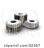Poster, Art Print Of Three Different Sized Chrome Gears Spinning Together