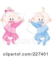 Cute Baby Twins In Pajamas Waving And Sucking On Pacifiers