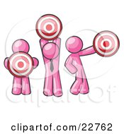 Group Of Three Pink Men Holding Red Targets In Different Positions by Leo Blanchette