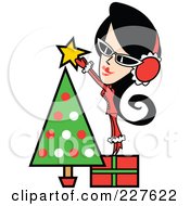 Retro Woman Standing On A Gift And Putting A Star Topper On A Christmas Tree