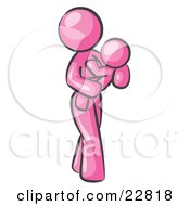 Clipart Illustration Of A Pink Woman Carrying Her Child In Her Arms Symbolizing Motherhood And Parenting