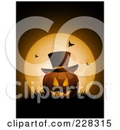 Halloween Jackolantern Wearing A Top Hat Resting In Grass Against A Full Moon With Bats