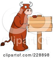 Poster, Art Print Of Bull Pointing To A Blank Wooden Sign