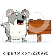 Poster, Art Print Of Koala Standing By A Blank Wooden Sign
