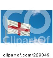 The Flag Of England Waving On A Pole Against A Blue Sky