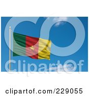 The Flag Of Cameroon Waving On A Pole Against A Blue Sky