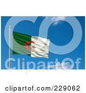 The Flag Of Algeria Waving On A Pole Against A Blue Sky