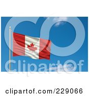 The Flag Of Canada Waving On A Pole Against A Blue Sky