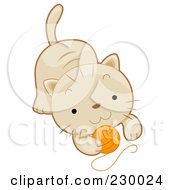 Cute Beige Kitten Playing With A Ball Of Yarn