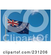 Flag Of New Zealand Waving On A Pole Against A Blue Sky