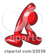 Red Man Sitting On A Gym Floor And Stretching His Arm Up And Behind His Head