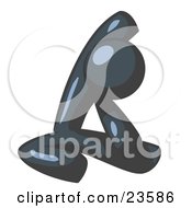 Navy Blue Man Sitting On A Gym Floor And Stretching His Arm Up And Behind His Head