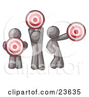 Group Of Three Gray Men Holding Red Targets In Different Positions