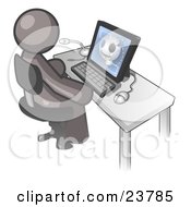 Gray Doctor Man Sitting At A Computer And Viewing An Xray Of A Head
