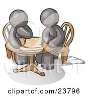 Two Gray Businessmen Sitting At A Table Discussing Papers
