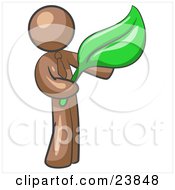 Clipart Illustration Of A Brown Man Holding A Green Leaf Symbolizing Gardening Landscaping Or Organic Products
