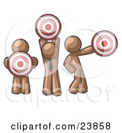 Group Of Three Brown Men Holding Red Targets In Different Positions