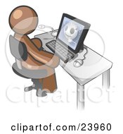 Brown Doctor Man Sitting At A Computer And Viewing An Xray Of A Head