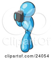 Clipart Illustration Of A Light Blue Man Character Tourist Or Photographer Taking Pictures With A Camera