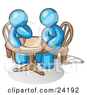 Two Light Blue Businessmen Sitting At A Table Discussing Papers